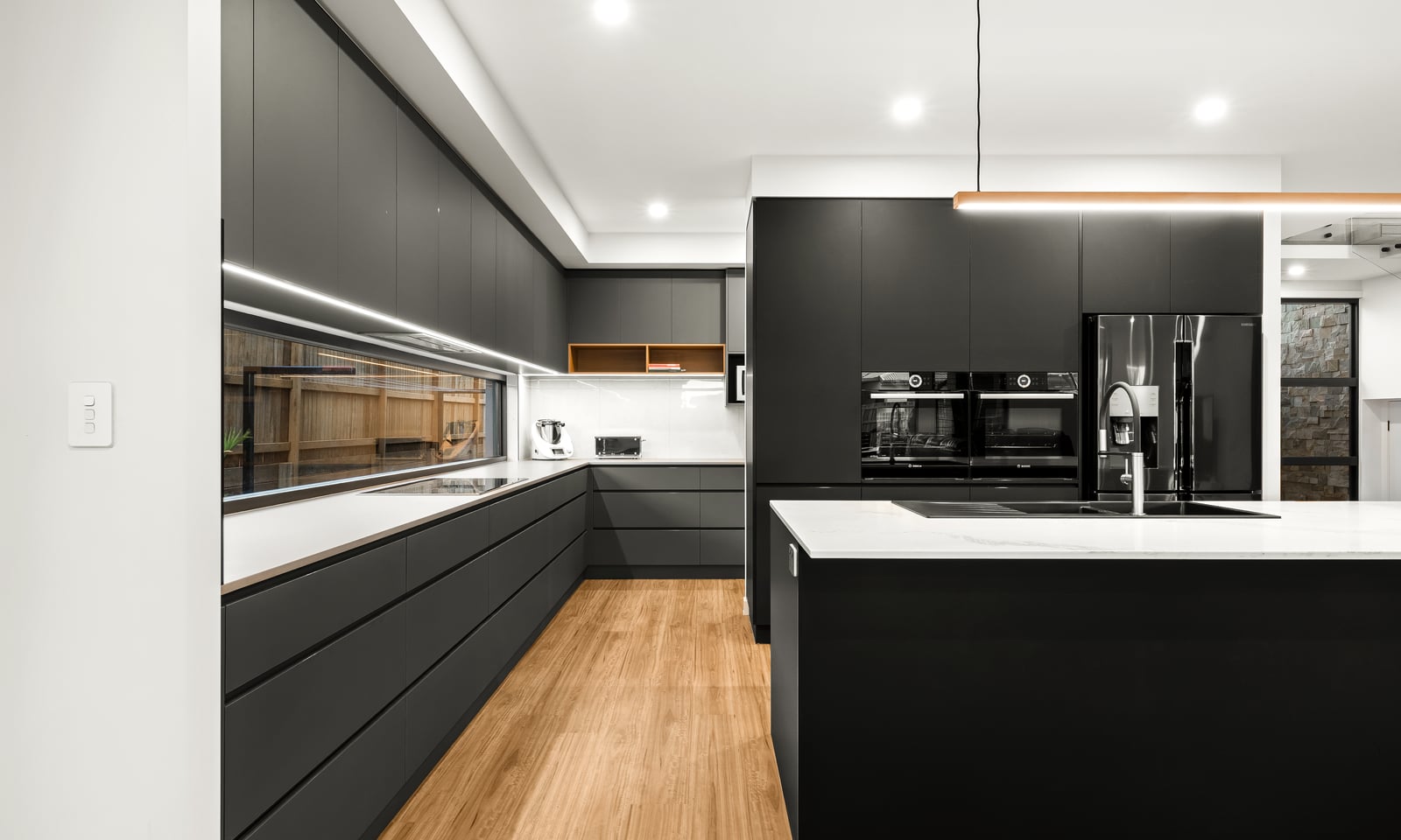 Project Thurston (Dark handleless kitchen with white benchtops, black island and timber floors)