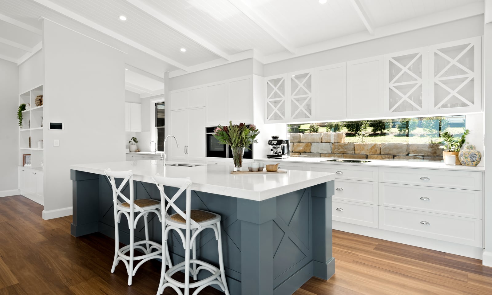 Project Trafalgar (Hamptons kitchen with slate-blue island, white X-mullion cabinets and rattan stools)