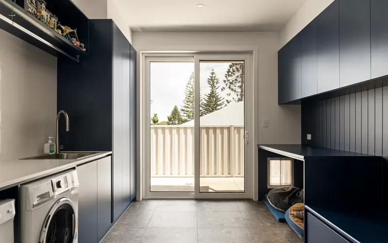 Modern laundry room with pet nook and outdoor view