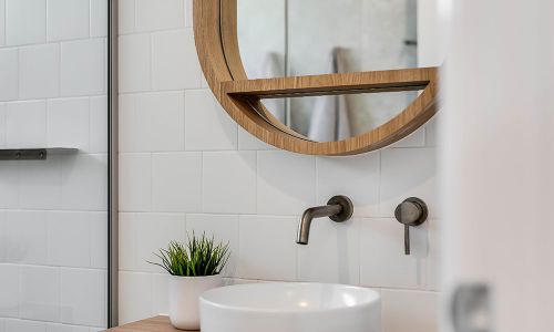 bathroom sink and circular mirror
