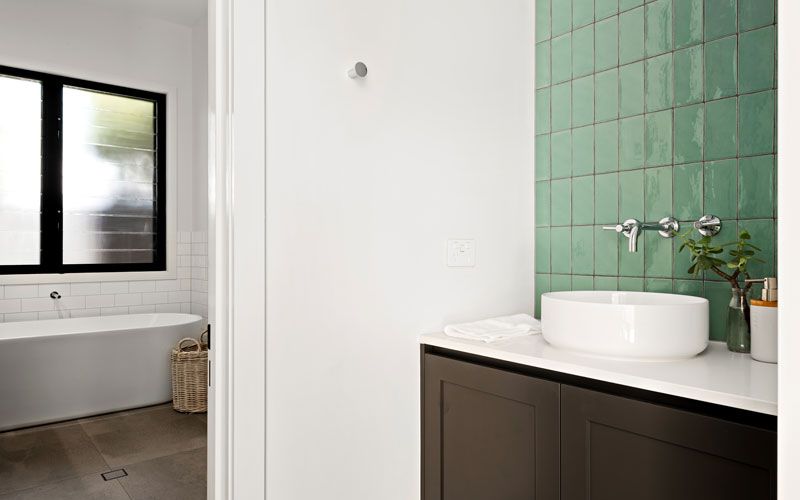 green tiled wall bathroom sink