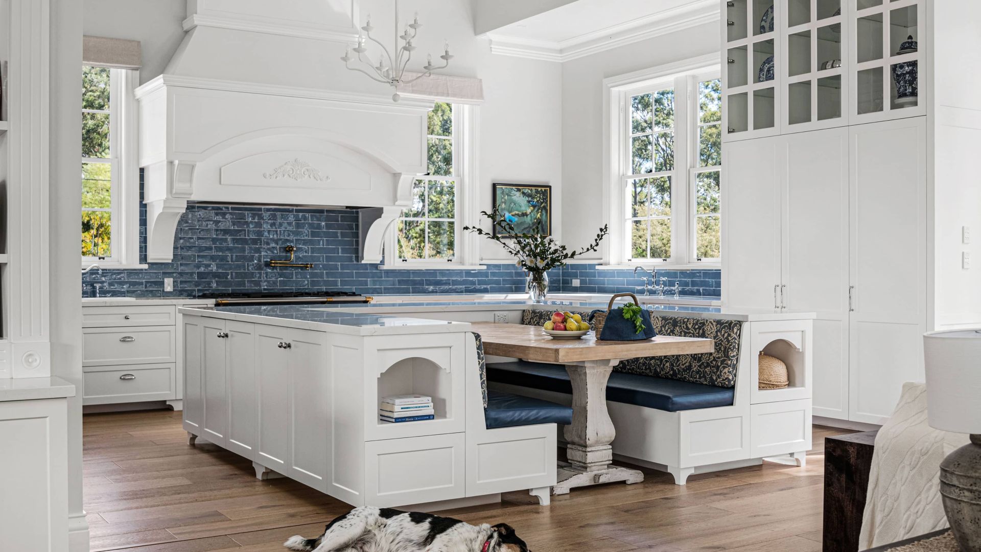 Dog lying on the floor with blue themed kitchen