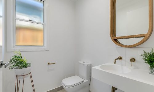 bathroom toilet and sink with mirror