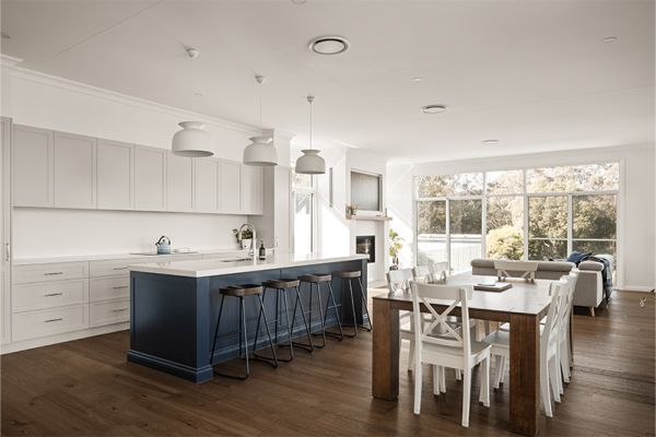 Spacious kitchen and dining area with large windows and contemporary fixtures.