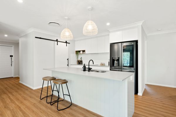 white themed kitchen with wooden floor