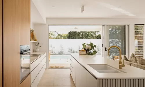 modern kitchen with white cabinets and wooden accents