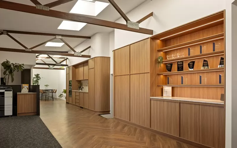 Award display and kitchenette in timber-accented office