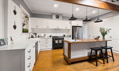 modern orange floored and white furniture kitchen side view