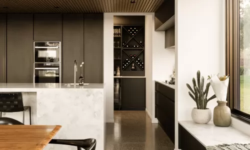 Modern kitchen with black cabinets, marble island, wine storage, and large window with plants