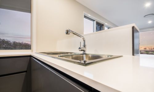 silver faucet with black cabinet