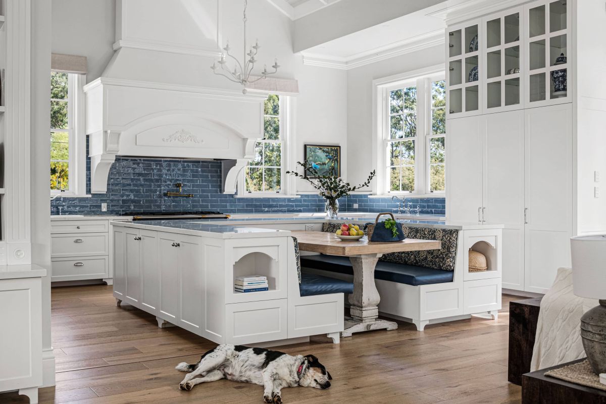 Dog lying on the floor with blue themed kitchen