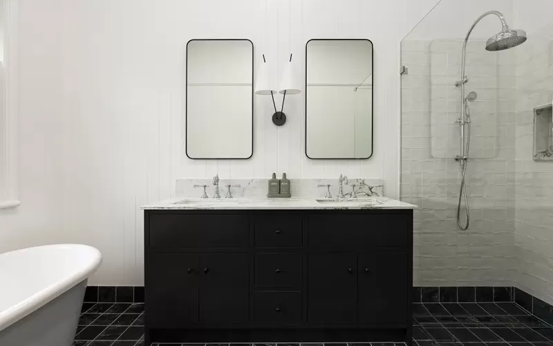 Dark green vanity with a single sink and Viola countertop.