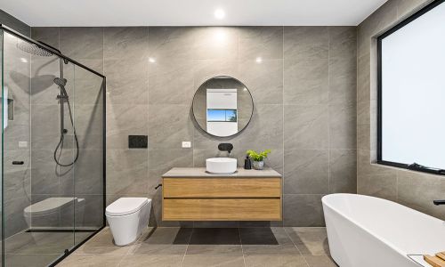 toilet and washroom sink with bathtub
