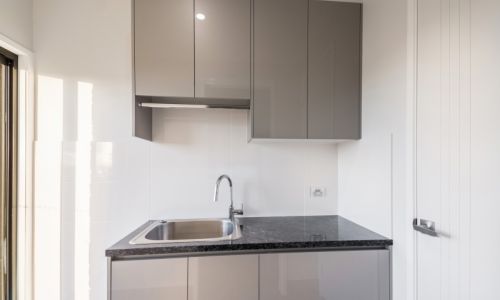 kitchen sink with gray cabinets