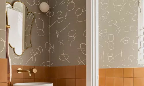 a wash room with a mirror, sink and faucet