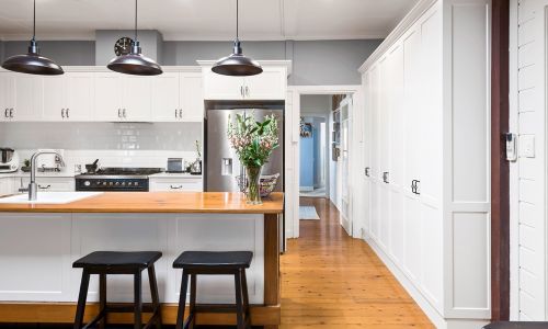 modern orange floored and white furniture kitchen
