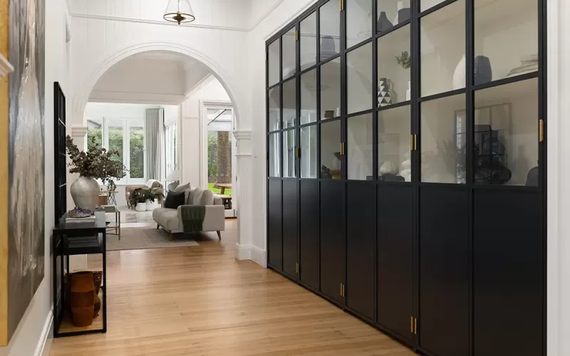 Black buffet cabinet with glass doors.