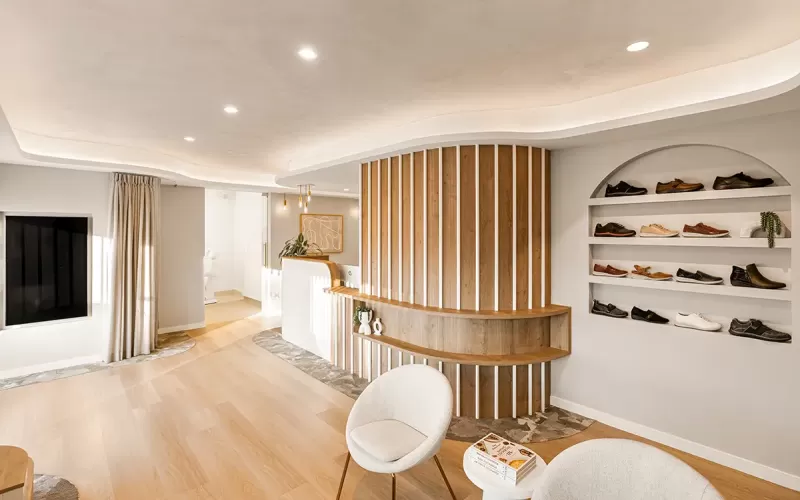 Reception view with curved wall, chairs, and shoe wall.