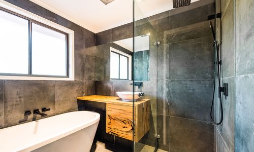 bathroom design with bath tub and glass divider