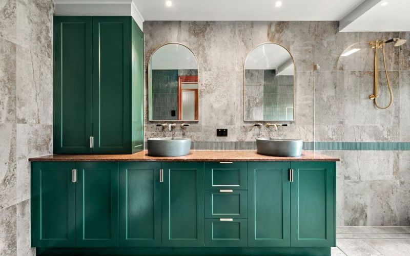 2 bathroom sink and mirror with green cabinets