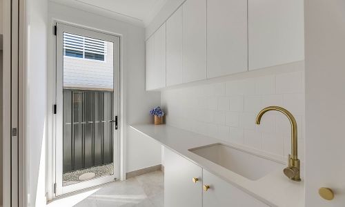 white cabinets with golden faucet sink
