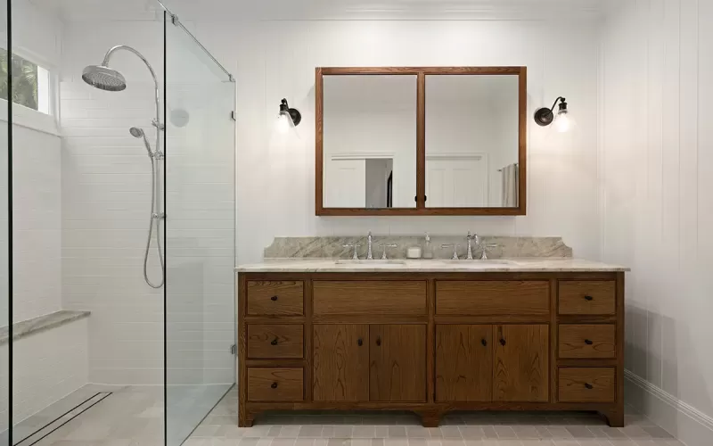 Dark green vanity with a single sink and Viola countertop.