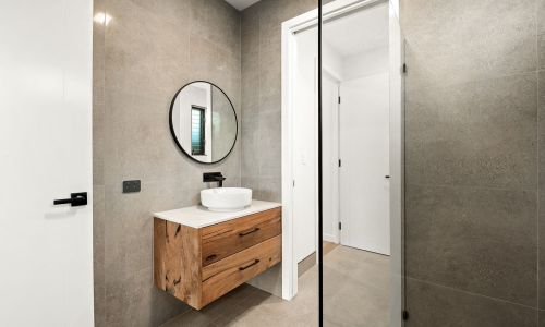 Circular mirror over washroom sink