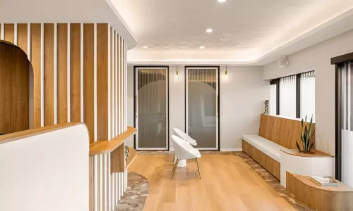 Bright waiting area with wood bench and modern chairs.