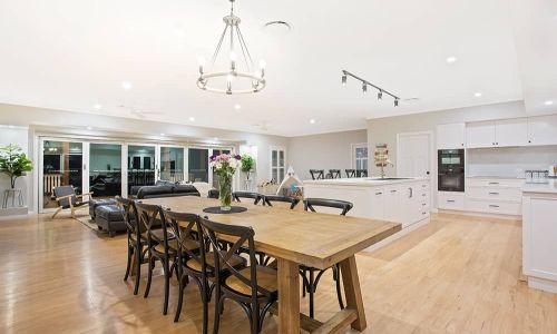 dining area wooden table and kitchen view