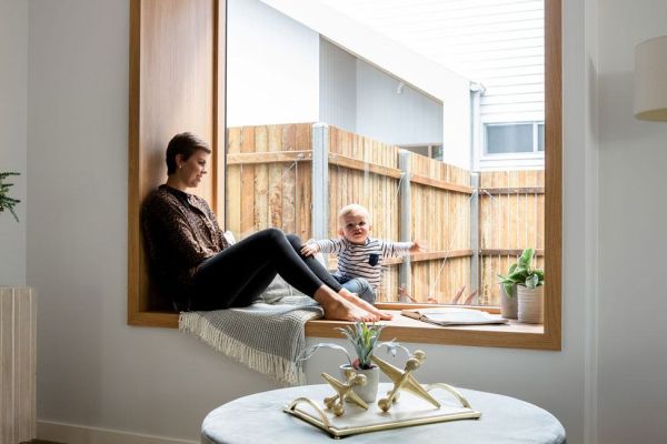 Drummond street glass window with wooden frame with a girl and a kid sitting