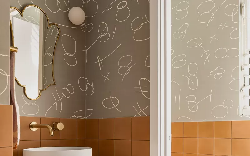 a wash room with a mirror, sink and faucet