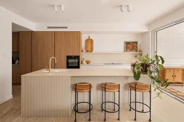 A modern kitchen with wooden cabinets and a white countertop