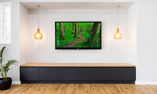 wall tv above wooden modern stationary