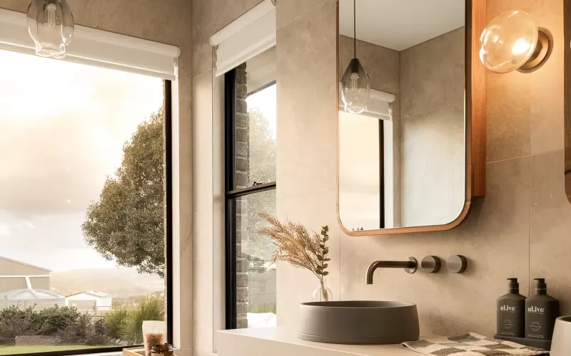 Modern bathroom with freestanding tub, wooden vanity, large windows, and stylish mirrors with lighting