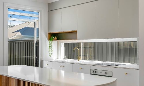 windowed style kitchen area with white cabinets
