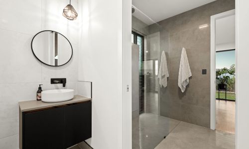 Bathroom with circular sink mirror