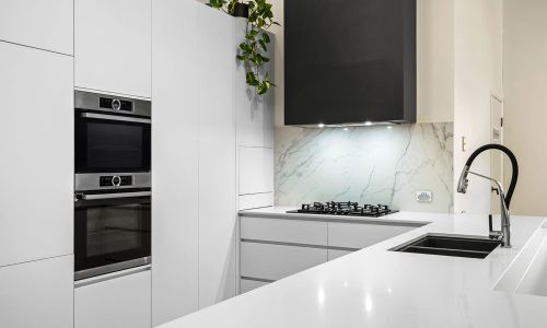 white colored cabinets and stove exhaust