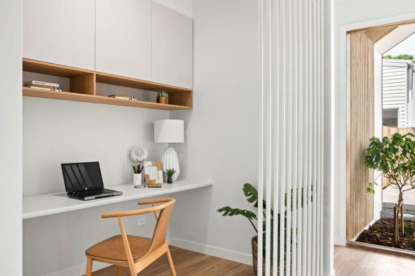 Drummond street office area in white and with wooden chair