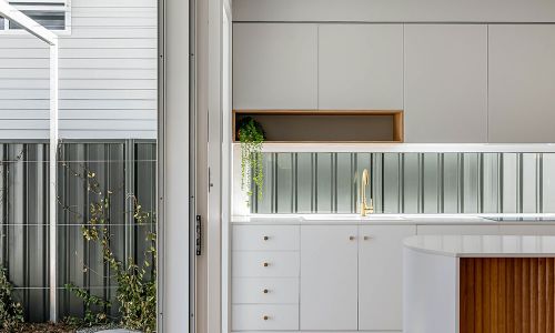large exit sliding door and white kitchen cabinets
