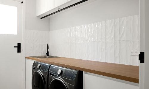 laundry room in white and black washing machine