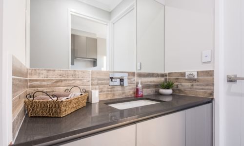 bathroom vanity section with large mirror