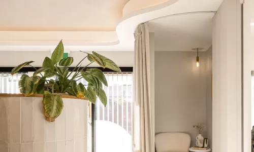 Curved ceiling, pendant lights, and cozy lounge nook.