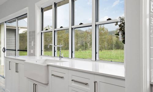 white sink and cabinets over a window