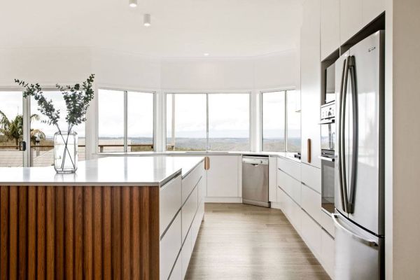 kitchen in white and wooden themed design with nice view