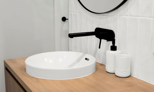 bathroom sink with black faucet