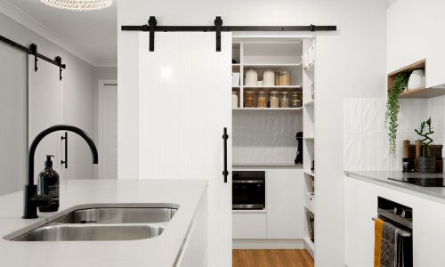white kitchen with the view of food storage