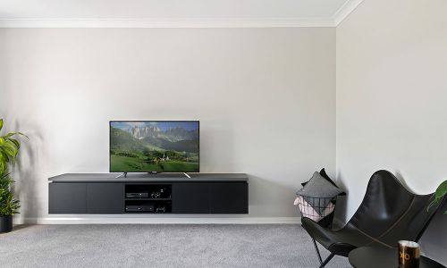 minimalist white wall and black TV cabinet