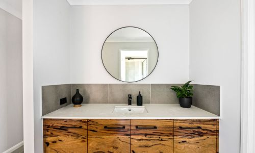 washroom sink with circular mirror