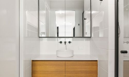 small washroom sink and cabinet mirror