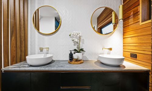 two bathroom sinks with two mirrors